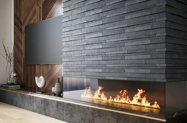 Modern living room with a fireplace, brick wall, and a TV.