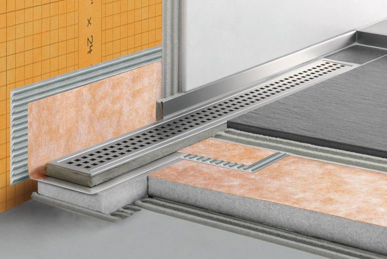 Cross-section of a shower floor with a linear drain system, showing layers of construction and orange waterproof board.