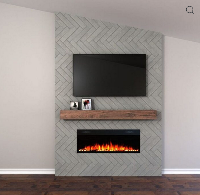 Grey herringbone-tiled accent wall with a TV, wooden shelf, and electric fireplace.