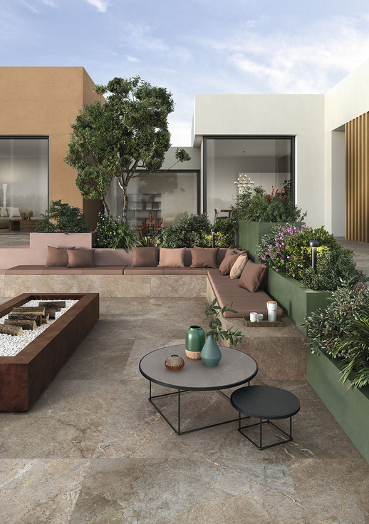 Outdoor patio with built-in seating, planters, and a fire pit; neutral tones, greenery, and modern furniture.