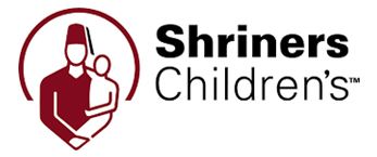 Logo of Shriners Children's: A man in a fez holds a child in a red and white circle. Text