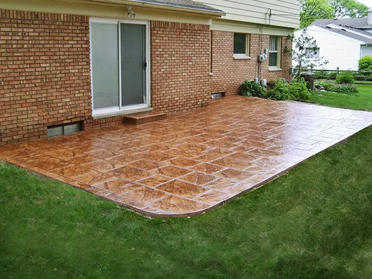 A brick house with a patio in front of it.