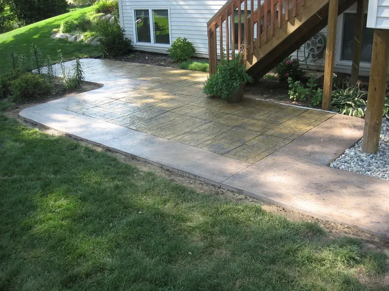 A patio with stairs leading up to a house