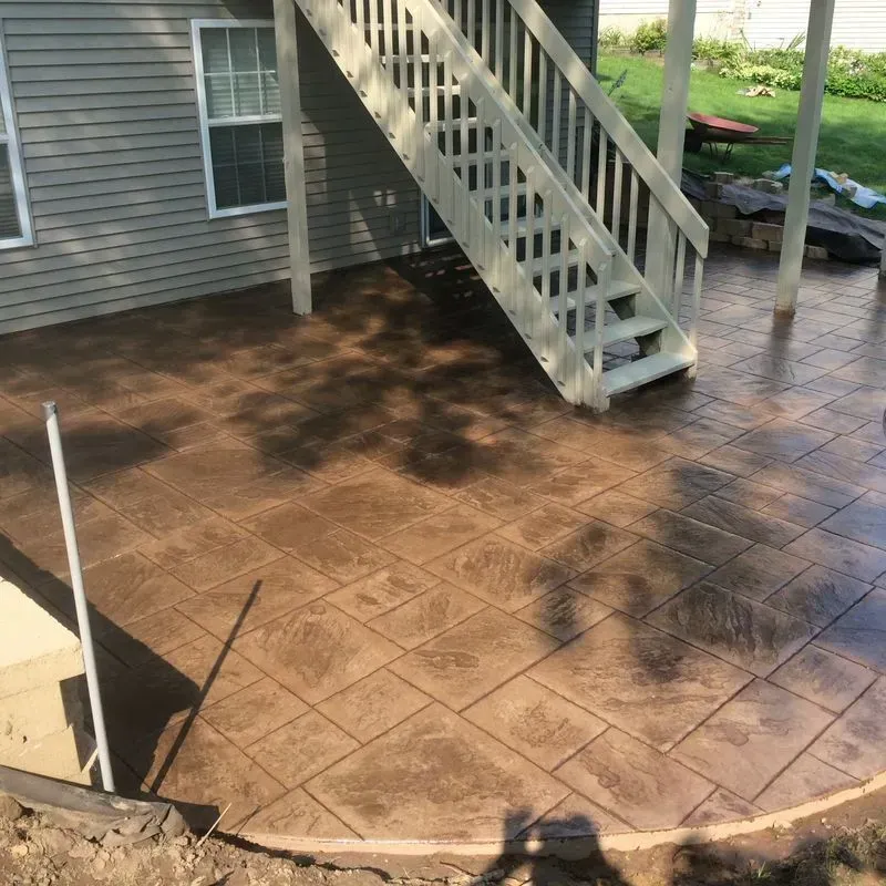 A patio with stairs leading up to a house