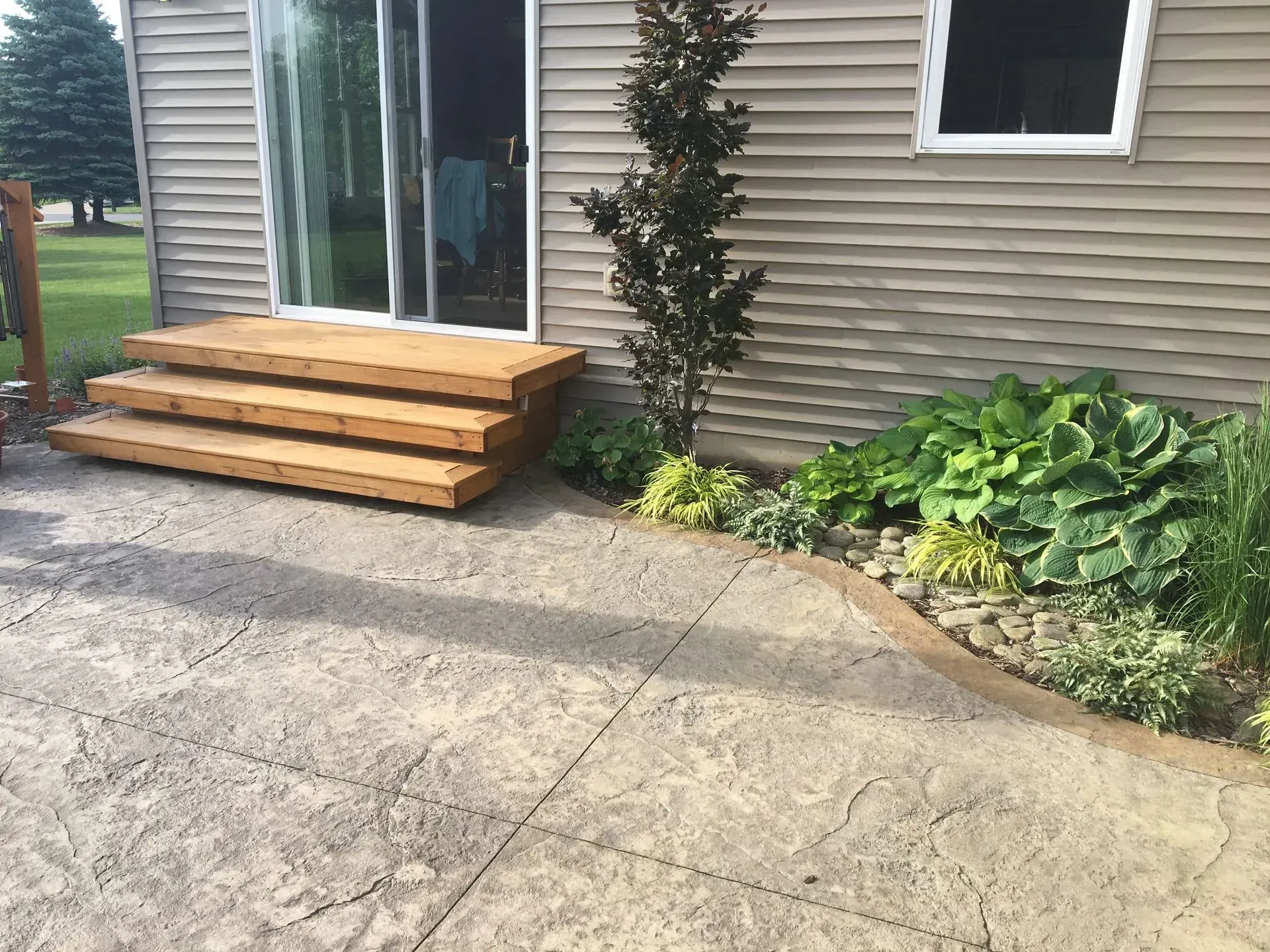 A house with a wooden deck and stairs in front of it