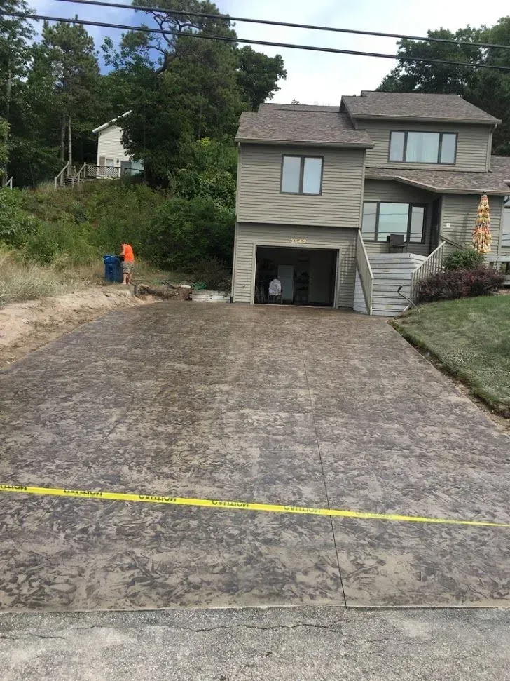 A large house with a brick driveway in front of it