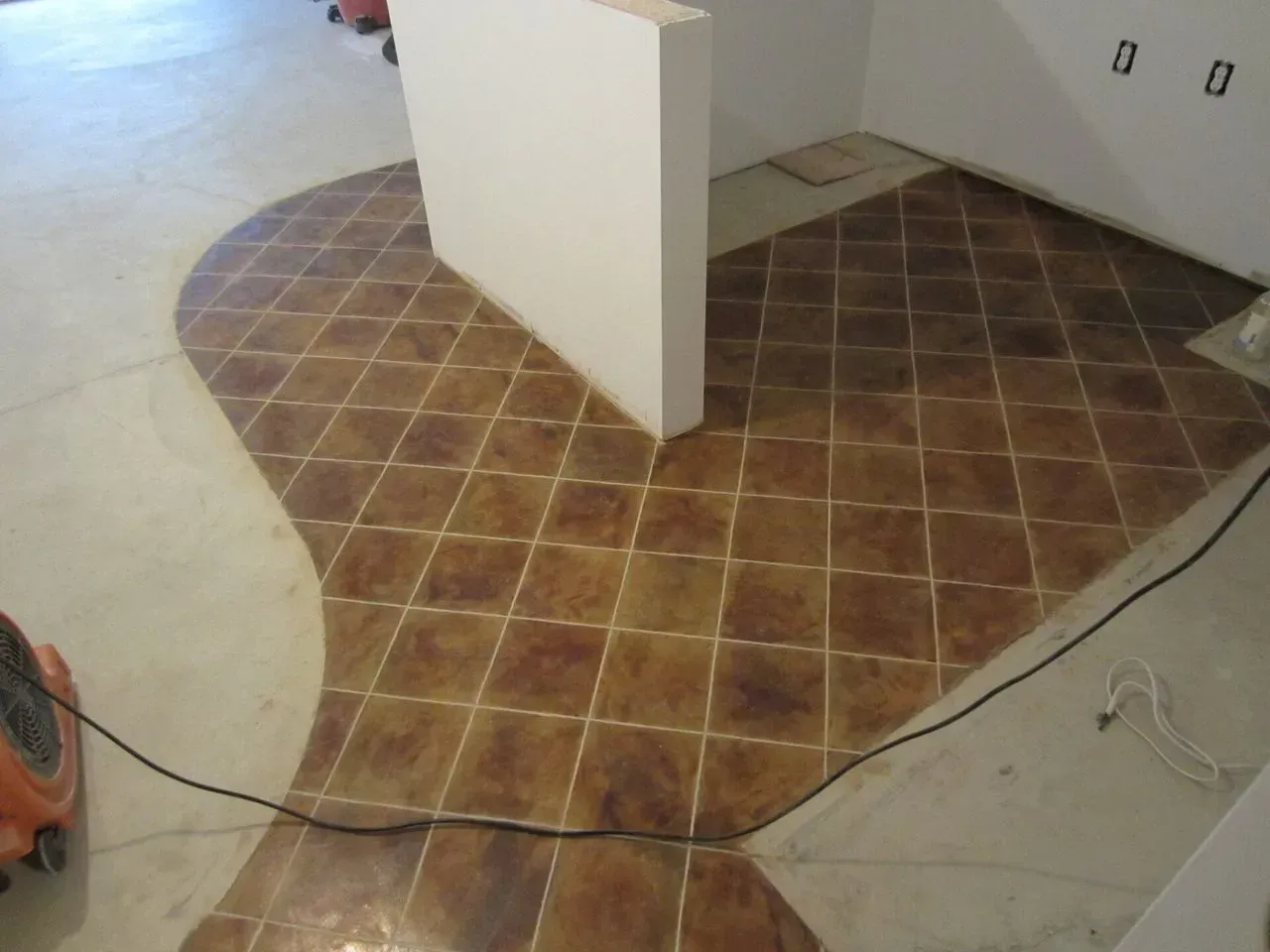 A vacuum cleaner is sitting on a tiled floor