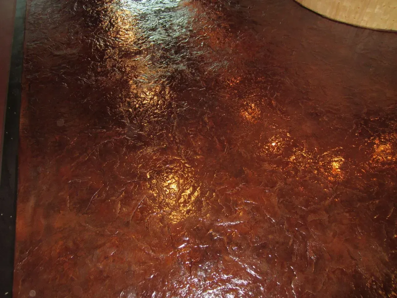 A close up of a brown surface with a shiny finish