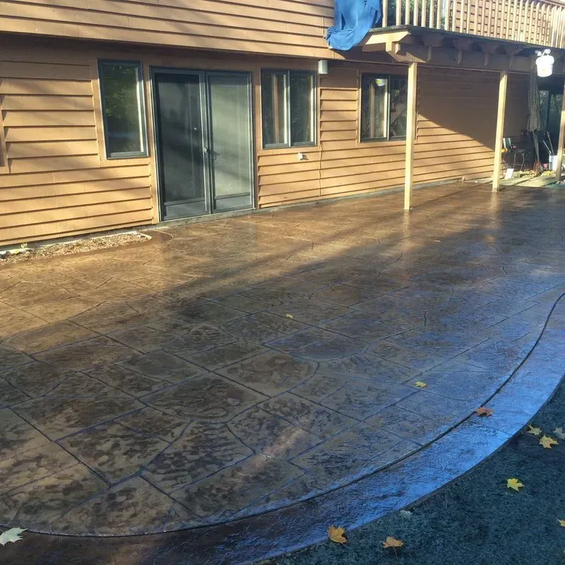 A house with a concrete patio in front of it
