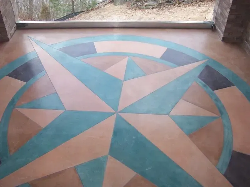 A compass on the floor with a window in the background