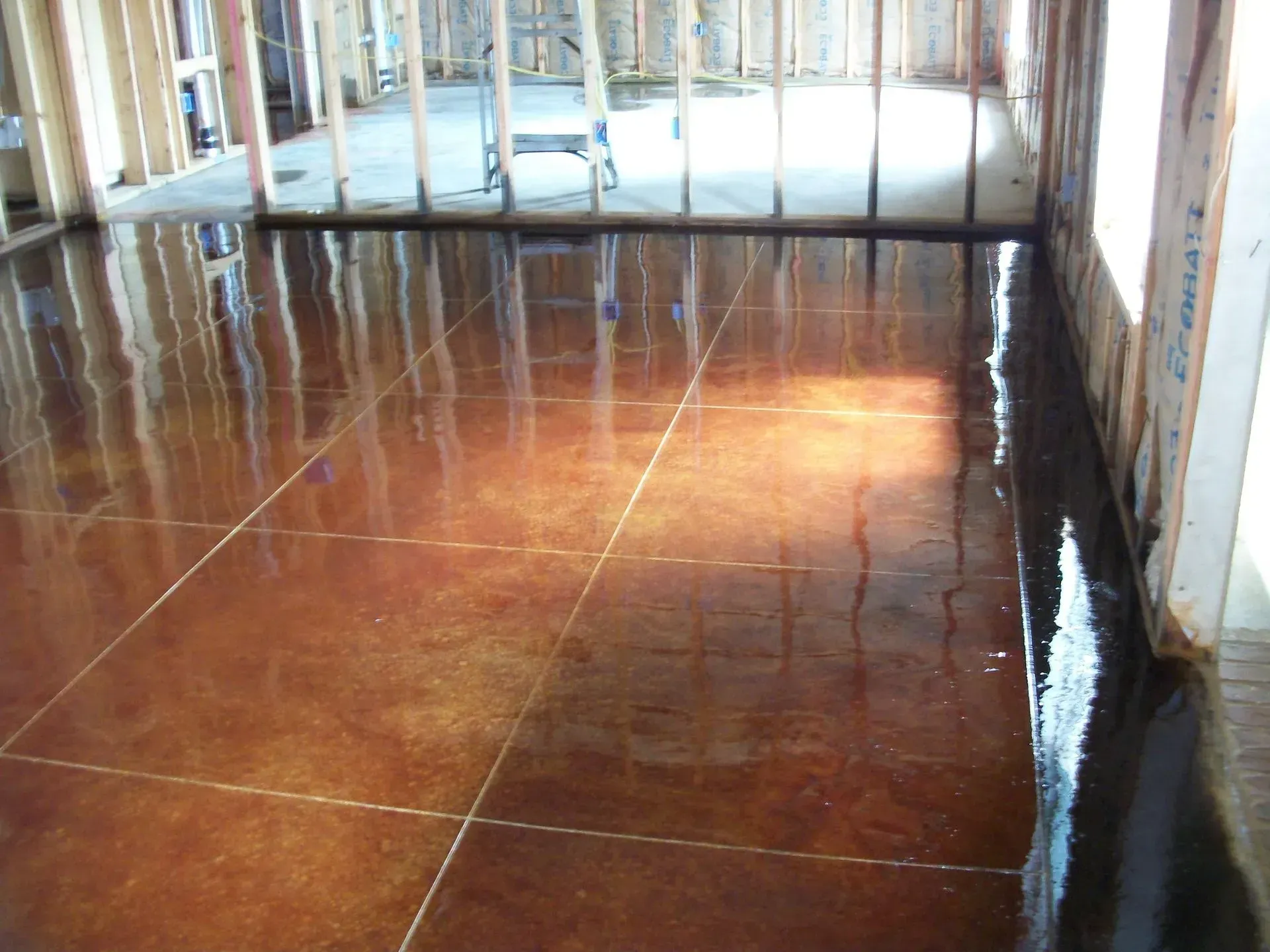 A shiny concrete floor in a room under construction