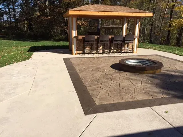 There is a fire pit in the middle of the patio.