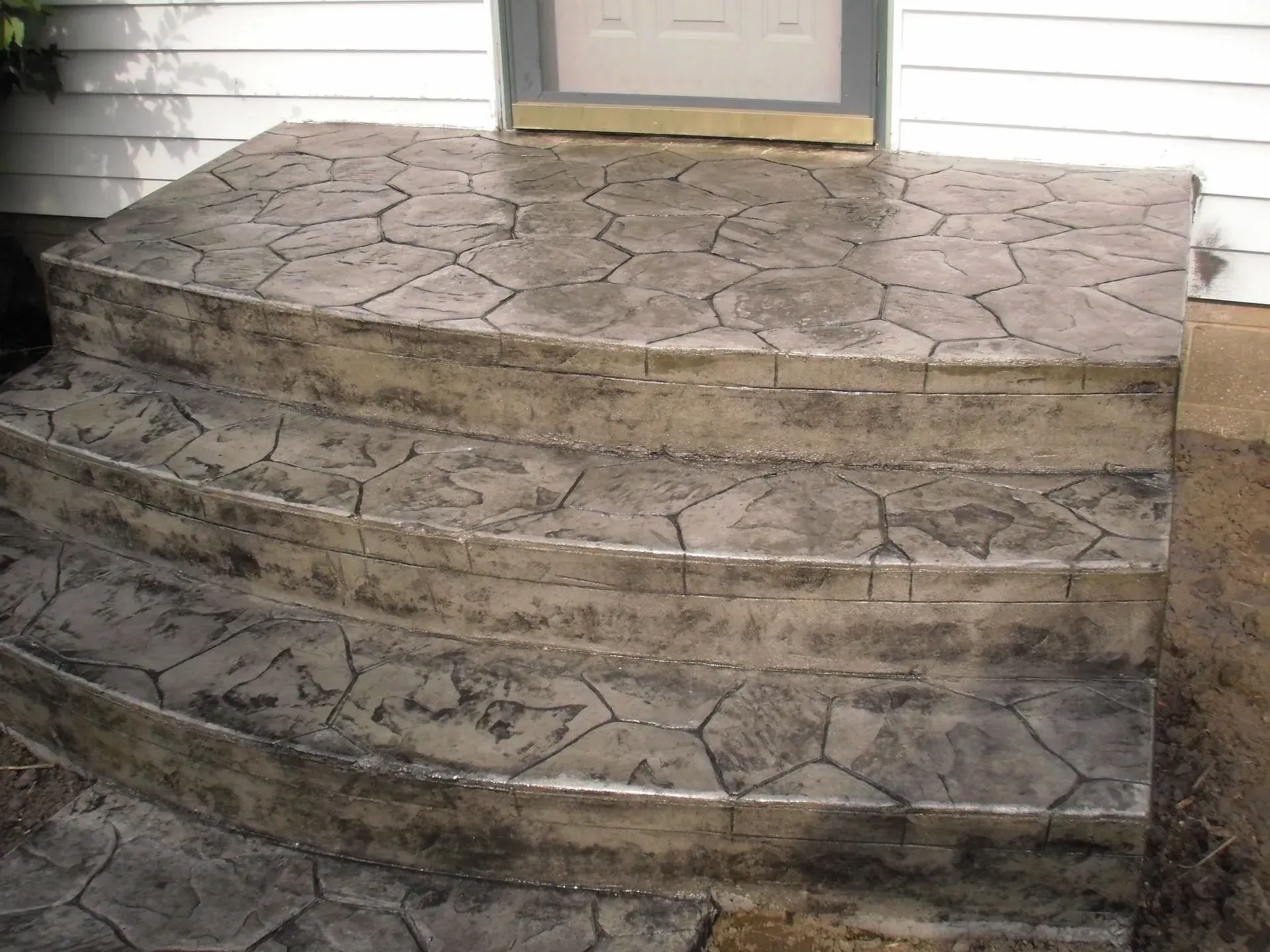 A set of concrete steps leading up to a door