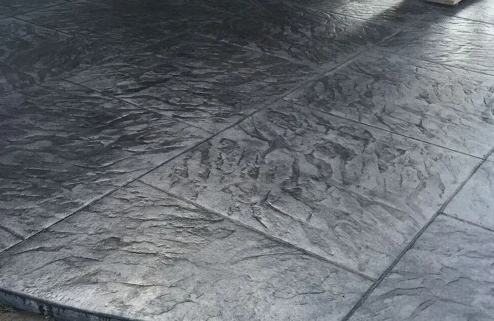 A close up of a concrete floor with a pattern on it.