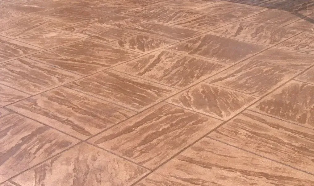 A close up of a concrete floor with a pattern on it.