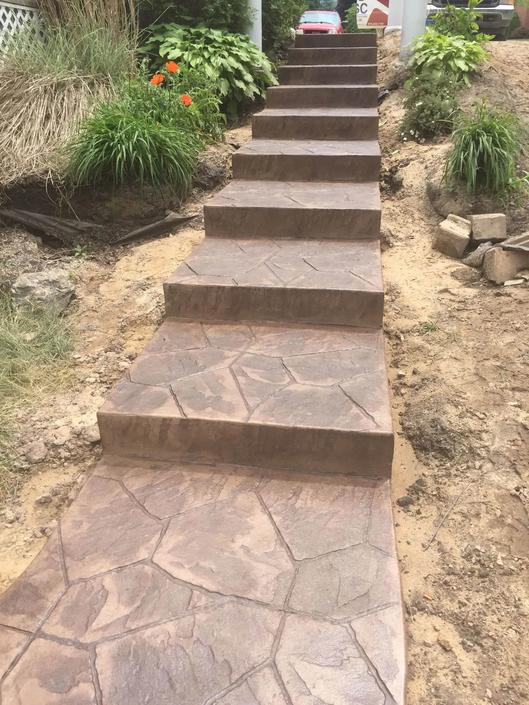 A set of concrete stairs leading up to a house.