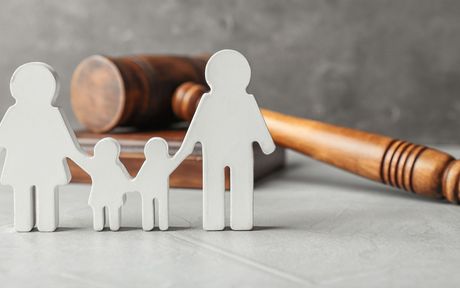 A wooden gavel with a family cut out of it.