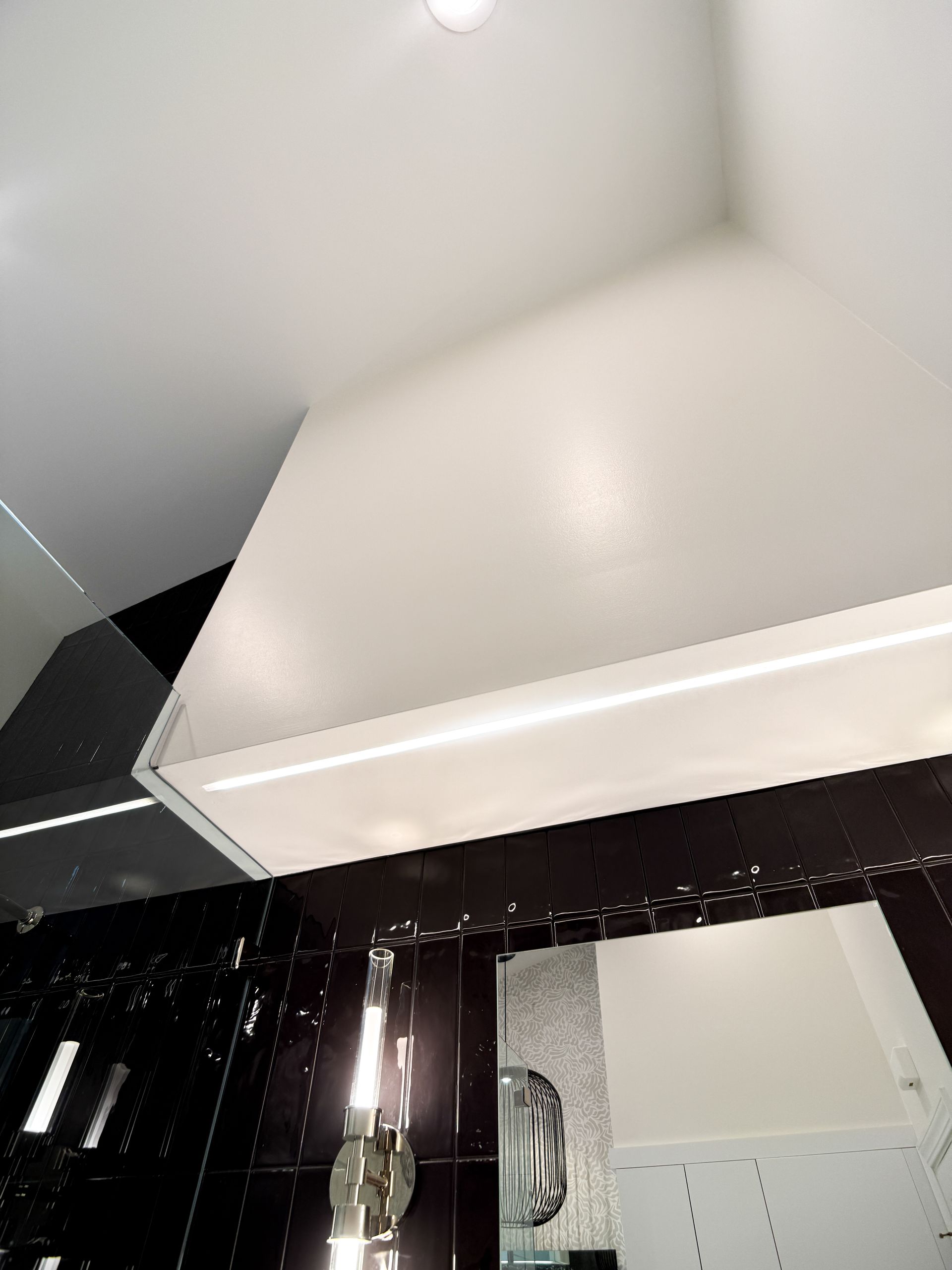 Kitchen ceiling and upper wall with white cabinetry and a dark curtain below