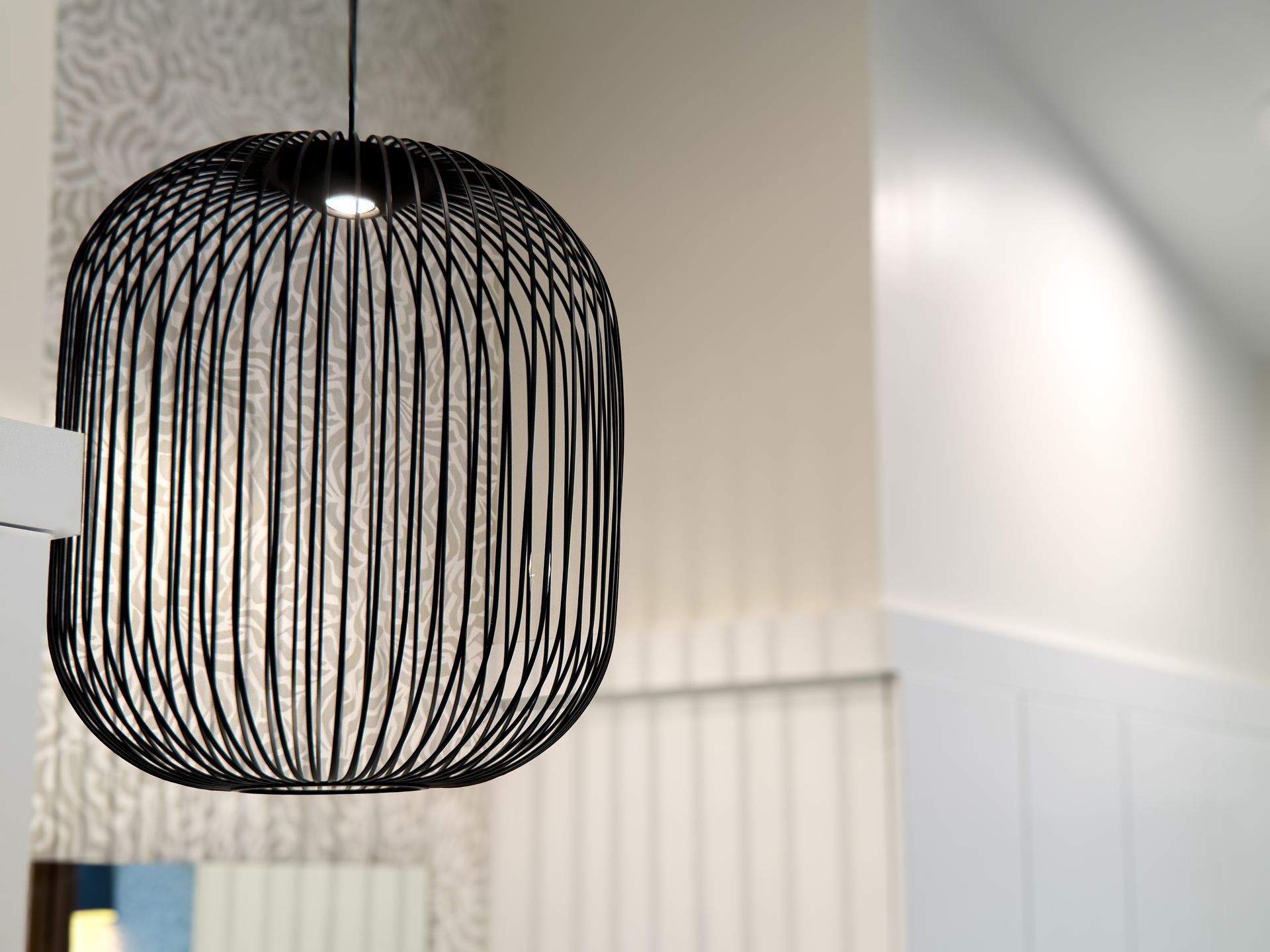 Black wire pendant lamp hanging in a bright, modern room
