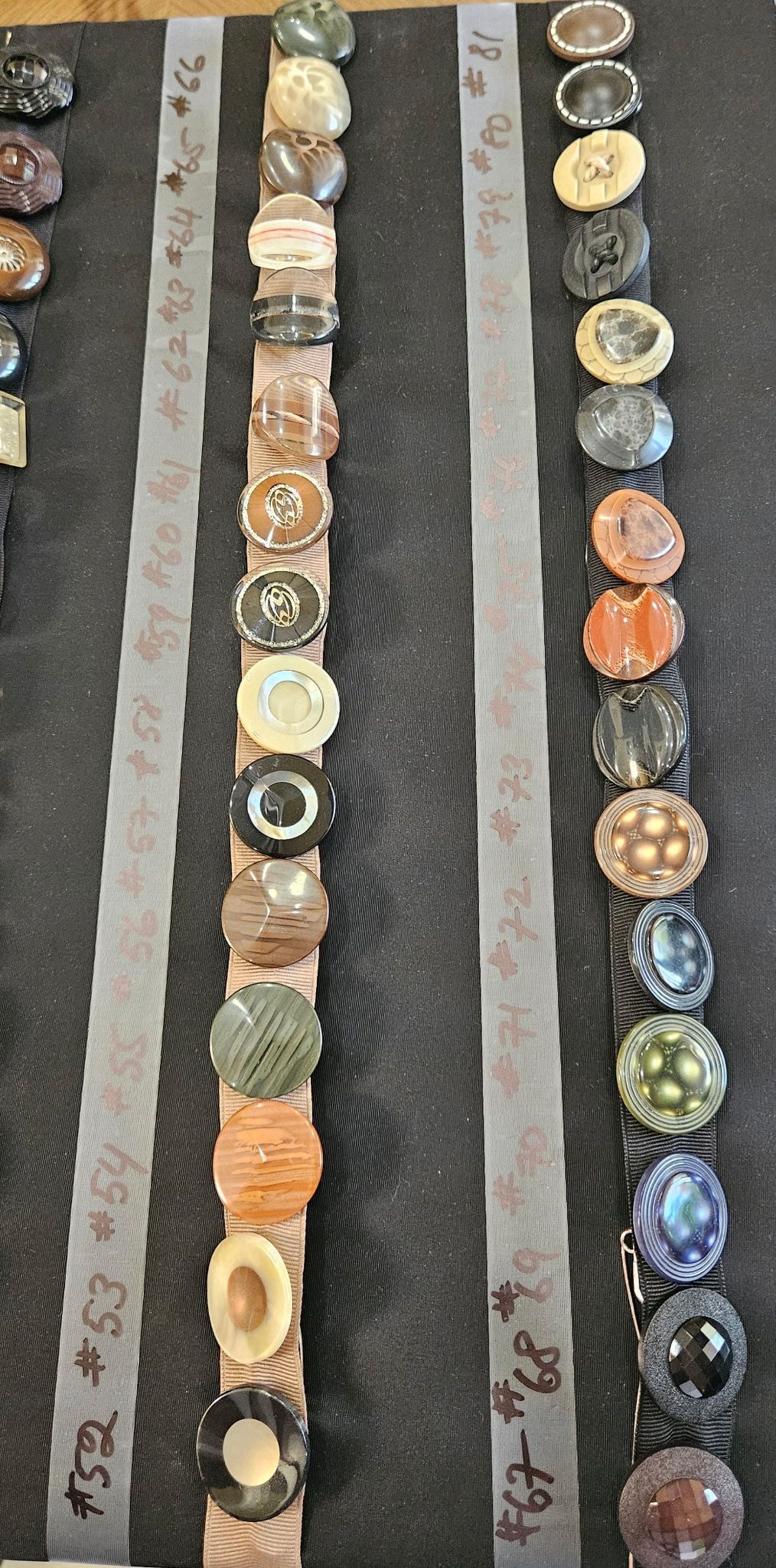 Vertical rows of assorted colorful coin-like discs on gray strips, arranged like a display or chart