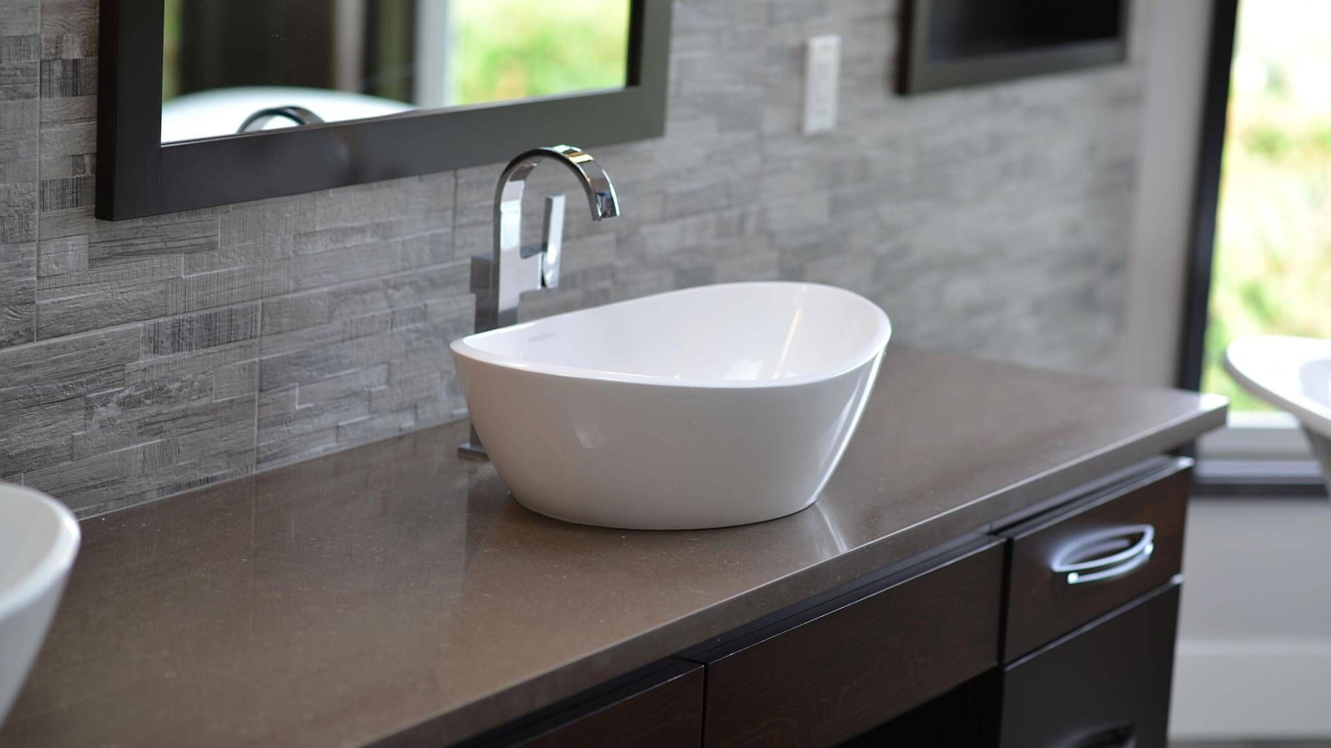 A bathroom with two sinks and a mirror.