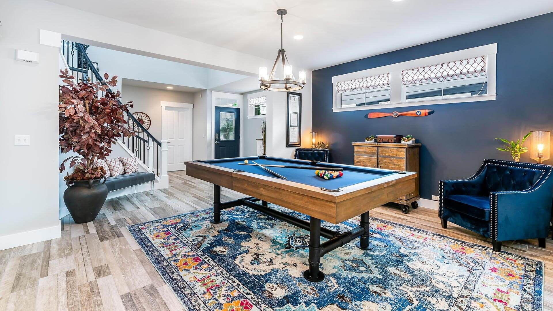 There is a pool table in the middle of the room.