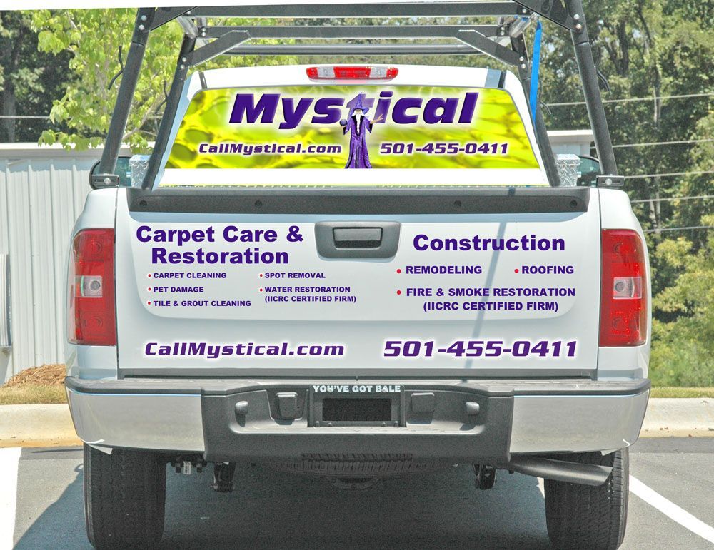 Back of a white truck with business advertisement for 