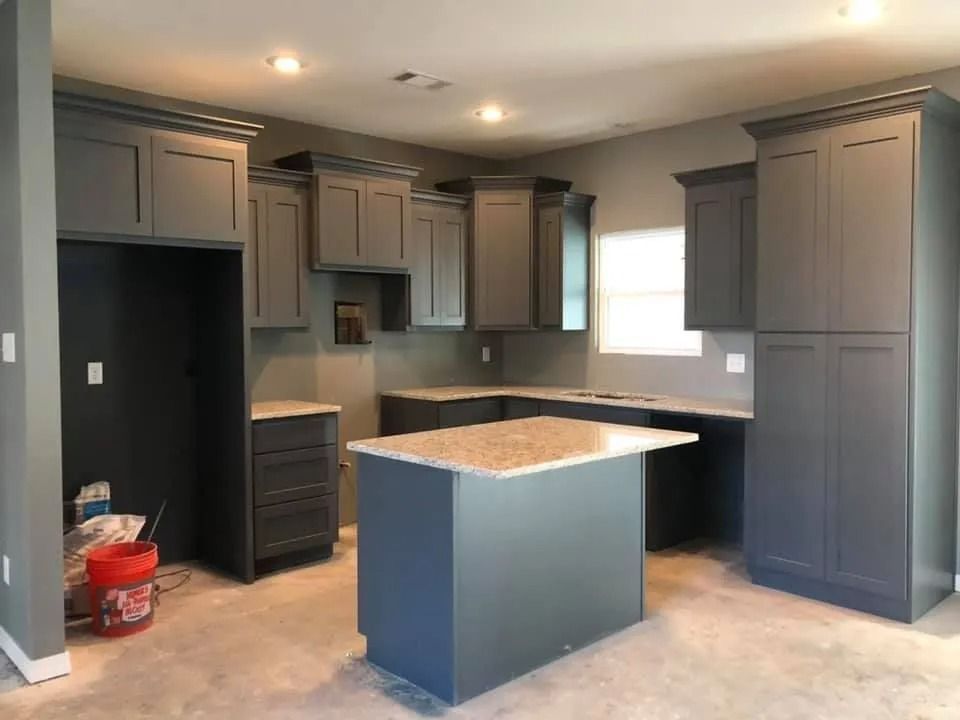 Gray kitchen with cabinets, island, and countertops; interior view.