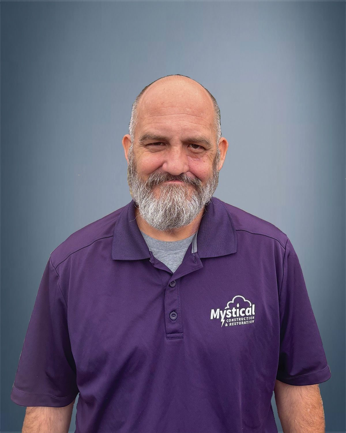 Man with gray beard wearing purple polo shirt with "Mystrol" logo.