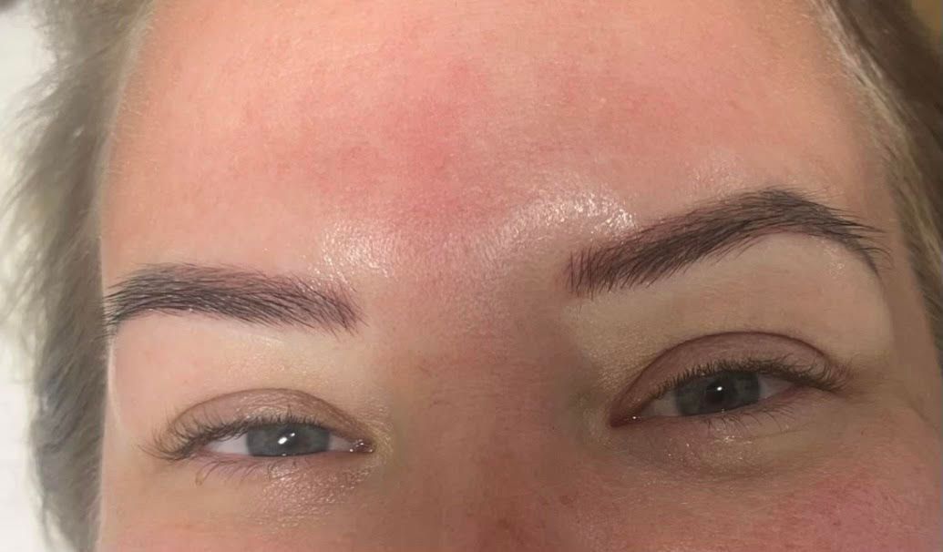 A close-up of a woman's eyebrows and forehead.