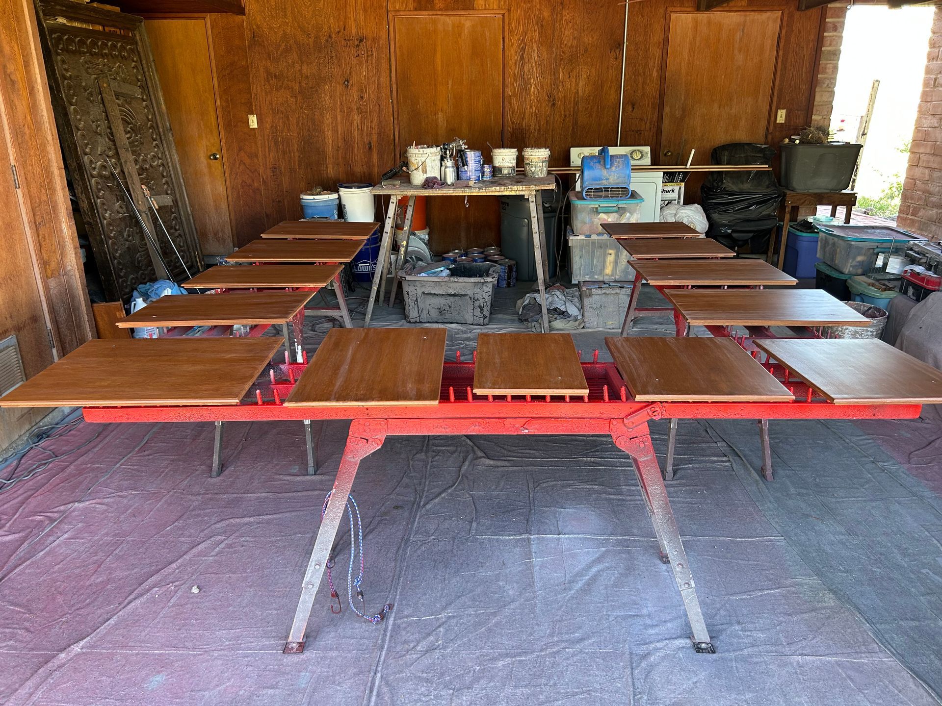 Wood-paneled room with rows of wooden tables and benches set up like a small classroom or meeting hall.