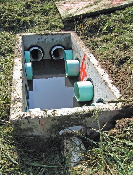 a concrete box filled with water and pipes