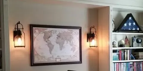 a living room with a map of the world hanging on the wall