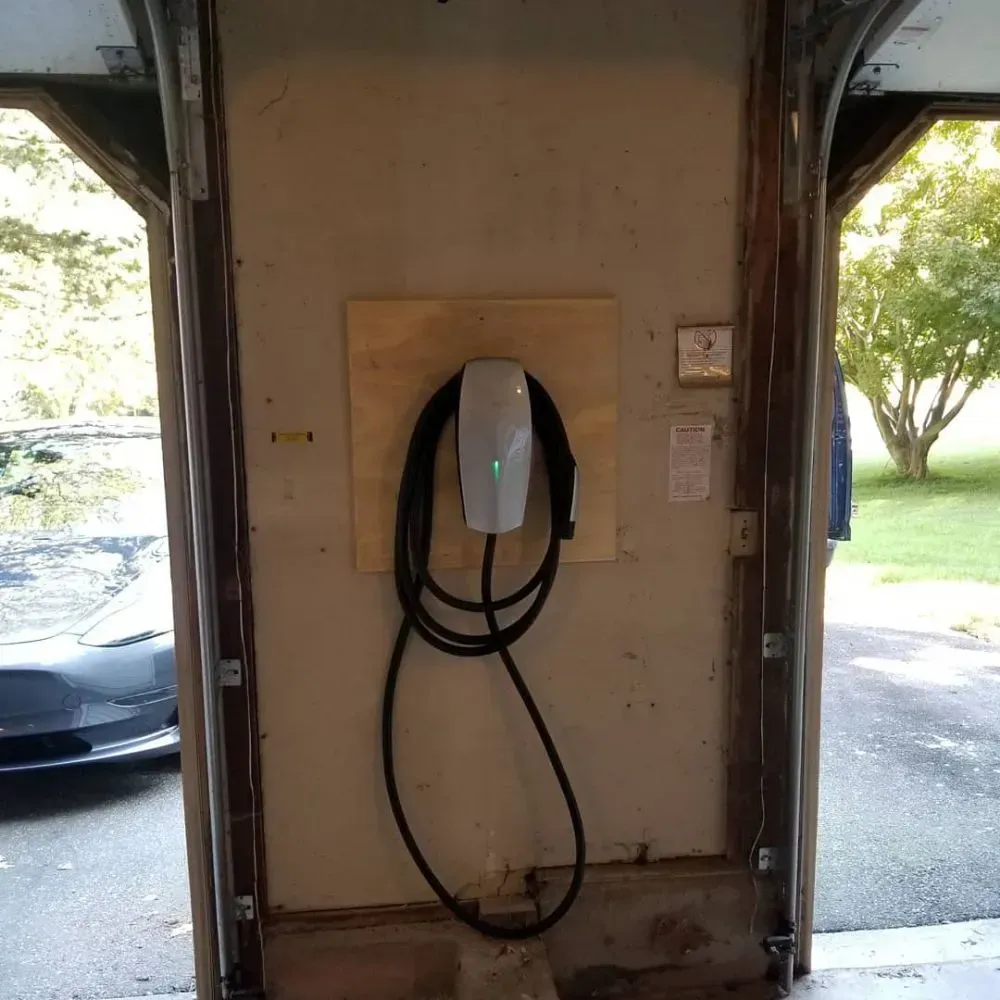 a tesla charging station is attached to a wall in a garage