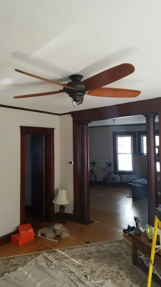 a ceiling fan is hanging from the ceiling of a living room
