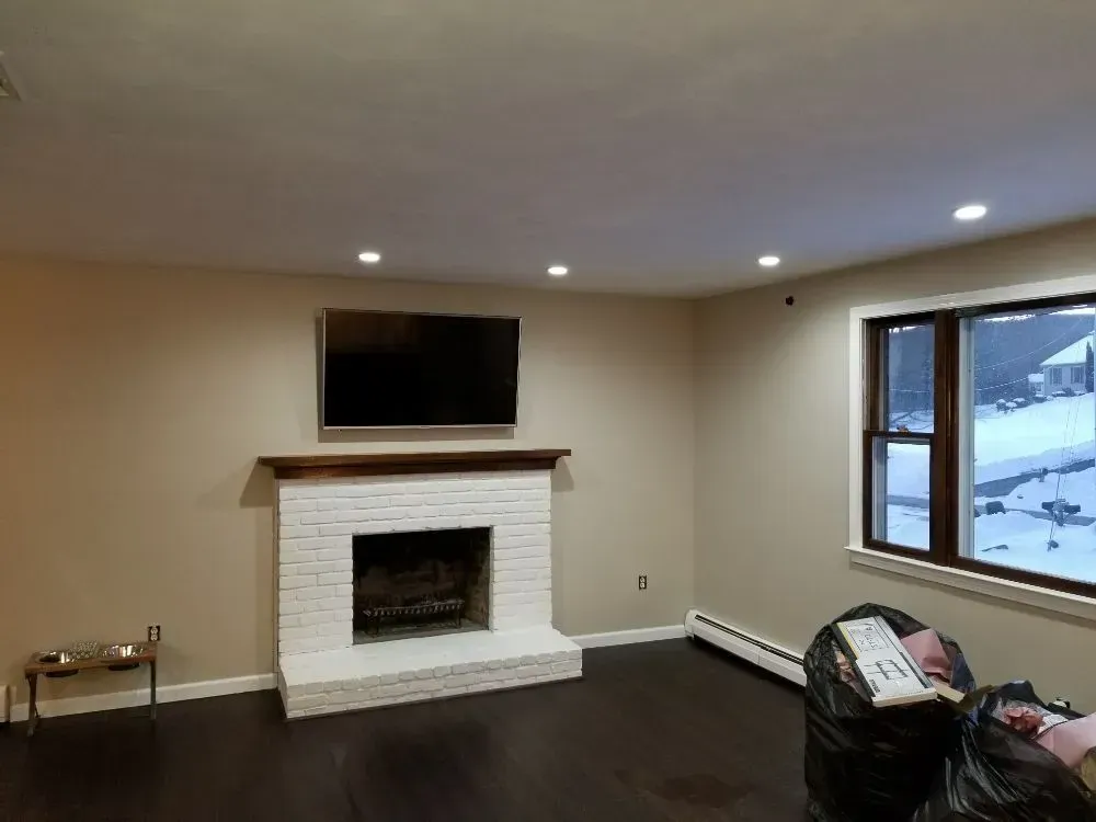 a living room with a fireplace and a flat screen tv