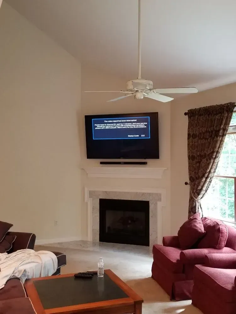 a living room with a fireplace and a flat screen tv on the wall