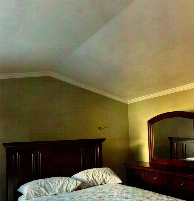 A bedroom with high-quality wall painting