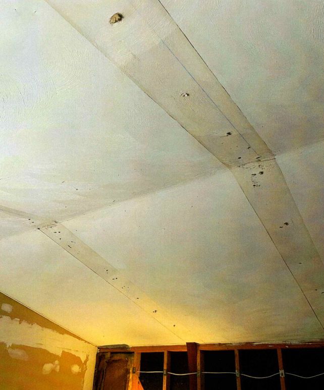 A white ceiling with a lot of holes in it