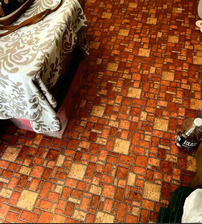 A room with a brown tile floor