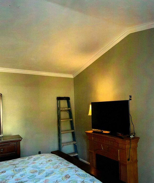 A bedroom with newly painted  walls and ceilings