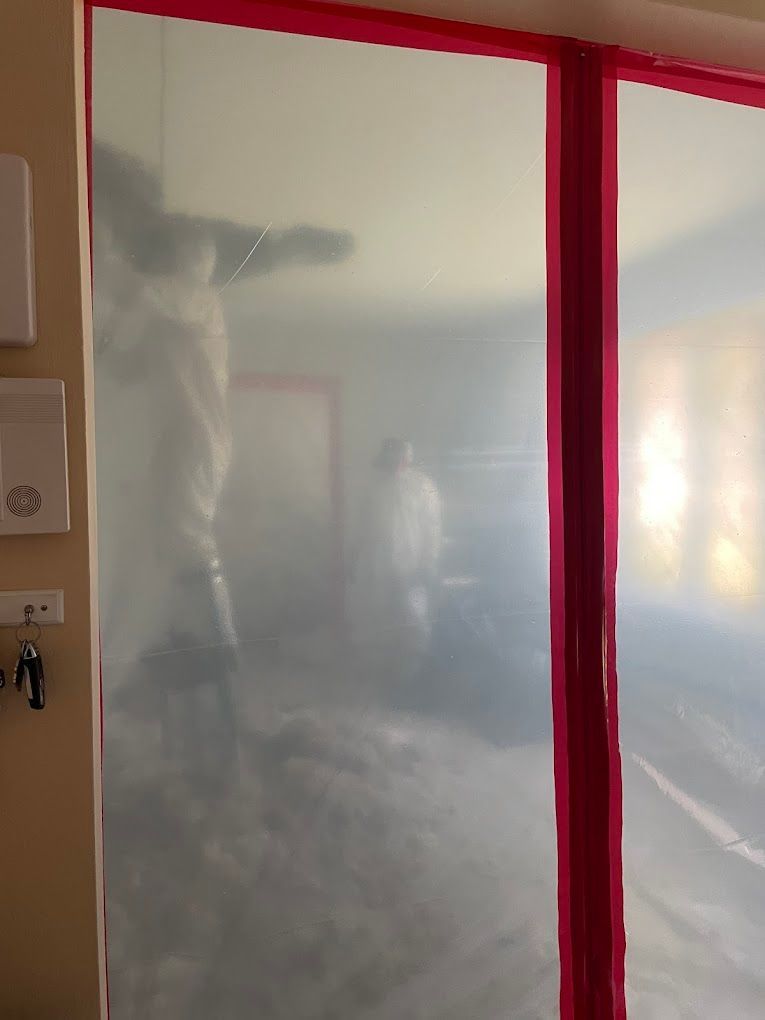 Room with a tarped-up wall and red tape