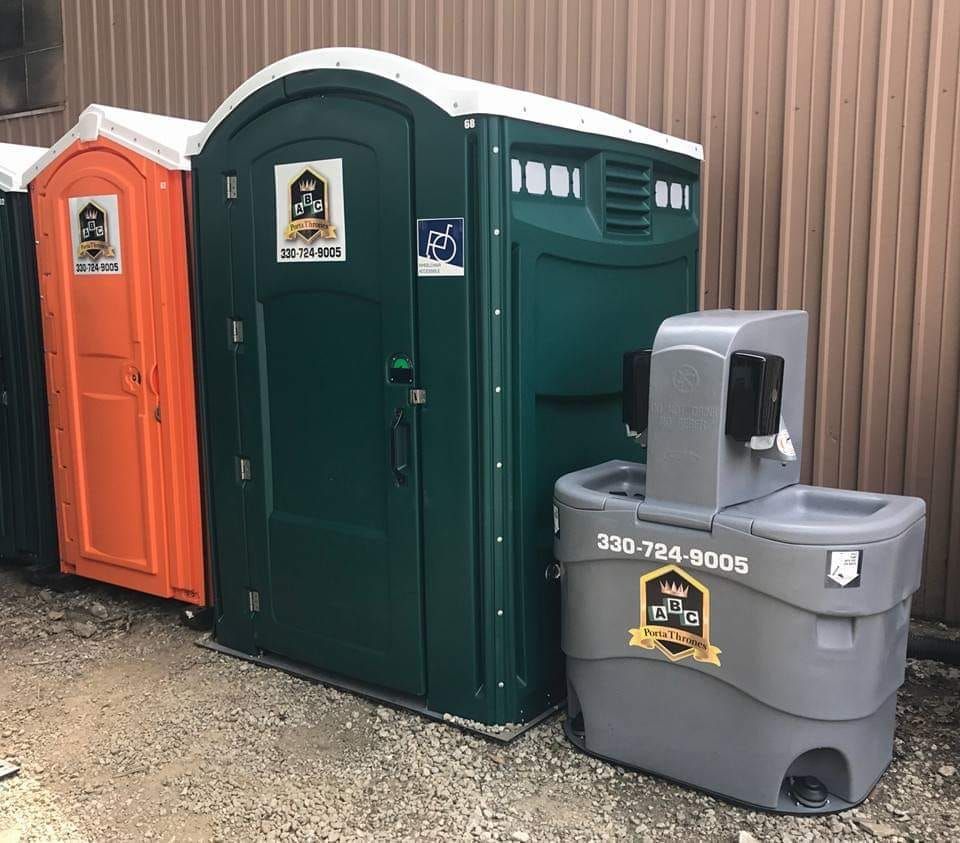 A row of portable toilets and a hand washing station
