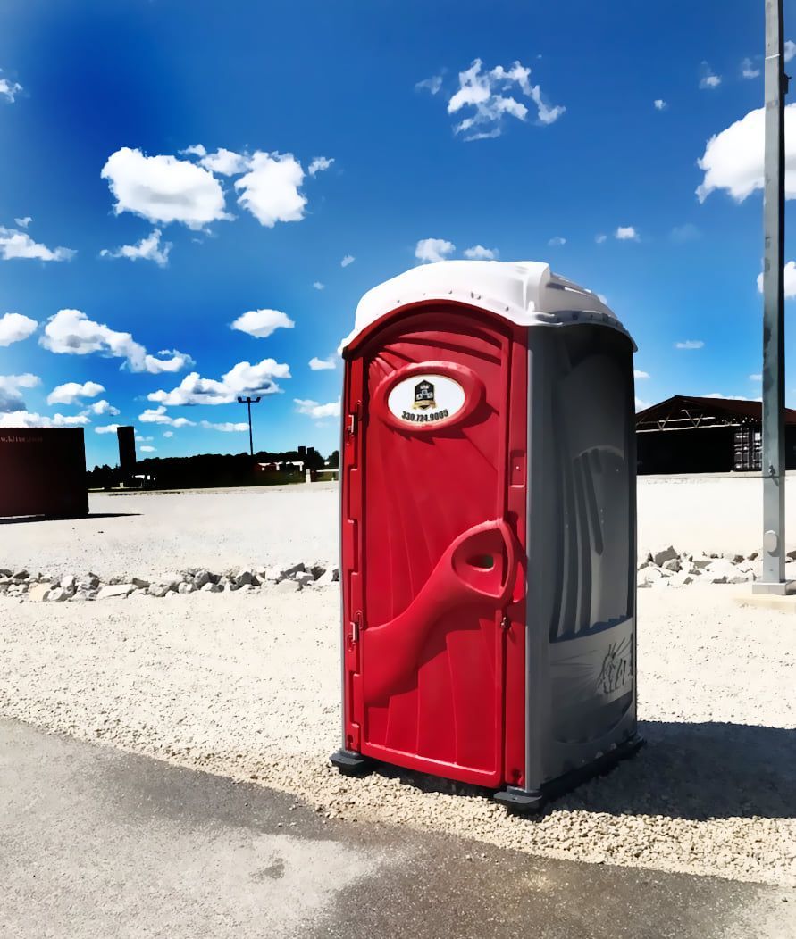 A red portable toilet with a coca cola logo on it