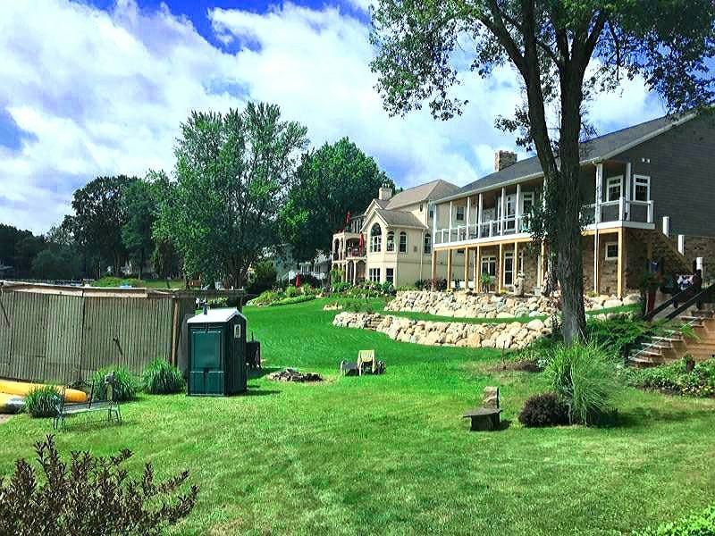 A large house with a large lawn in front of it.