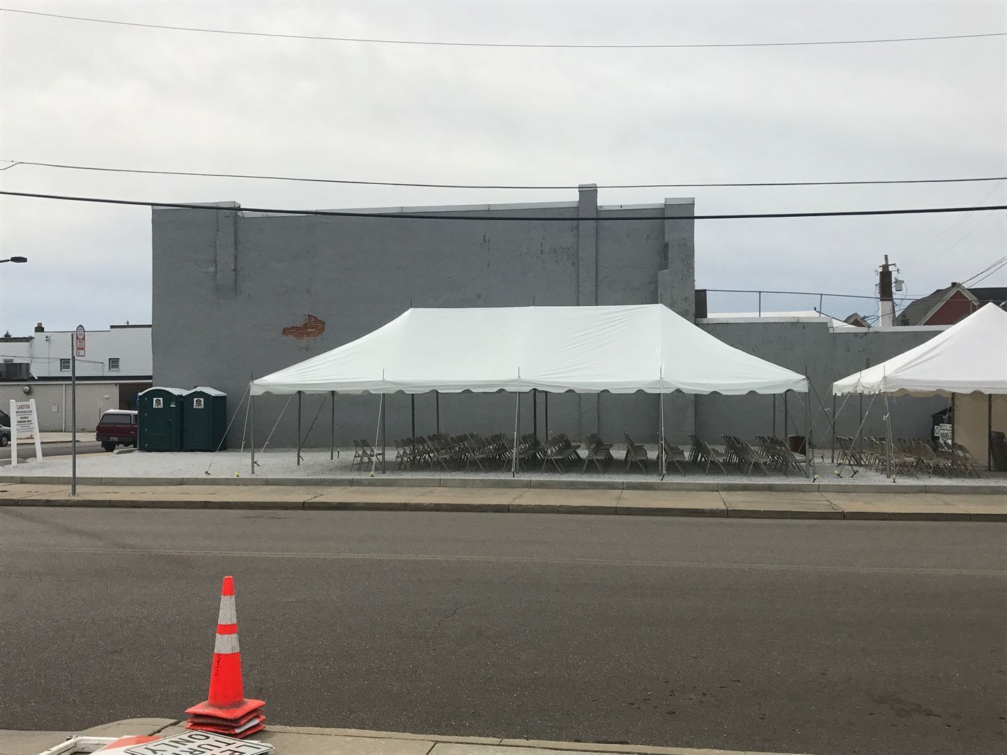 A row of tents are set up on the side of the road