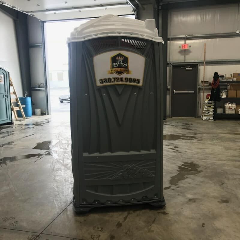 A portable toilet with a phone number on it
