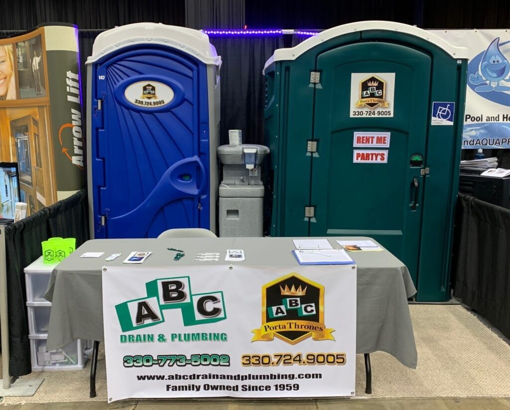 A table with a sign that says abc drain and plumbing on it.