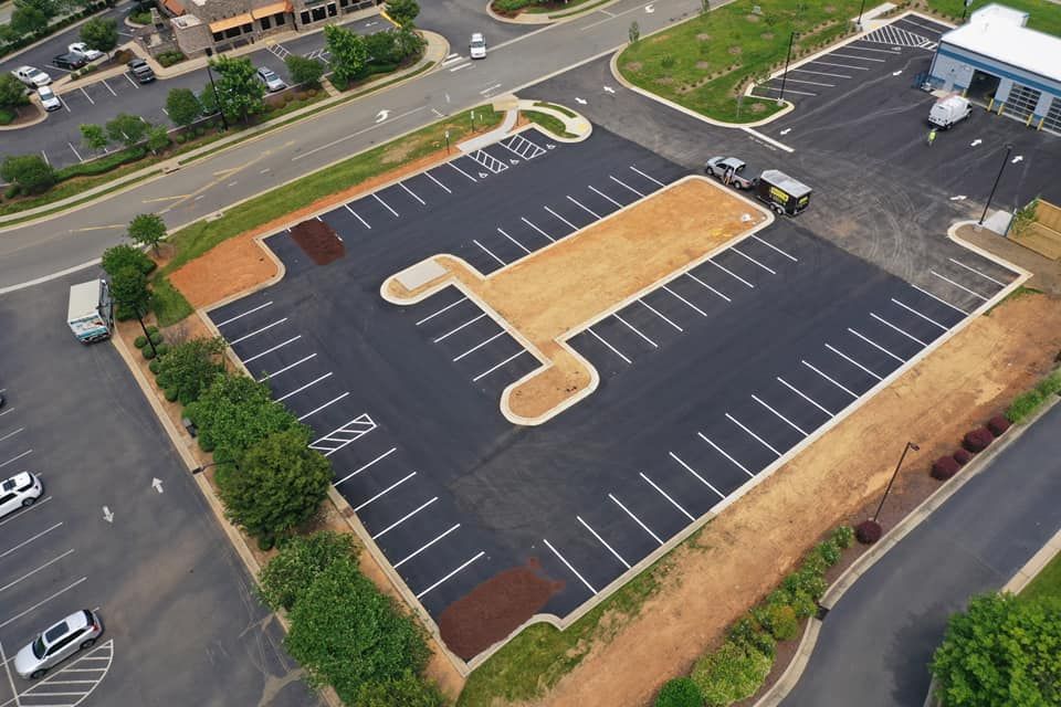 An aerial view of a parking lot with a cross painted on it