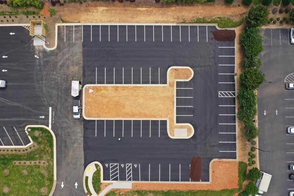 An aerial view of a parking lot with cars parked in it